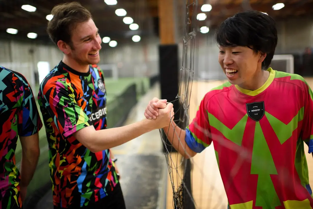 Two players wearing custom Toffee Football League football jerseys by VO2. Portland, Oregon. USA.
